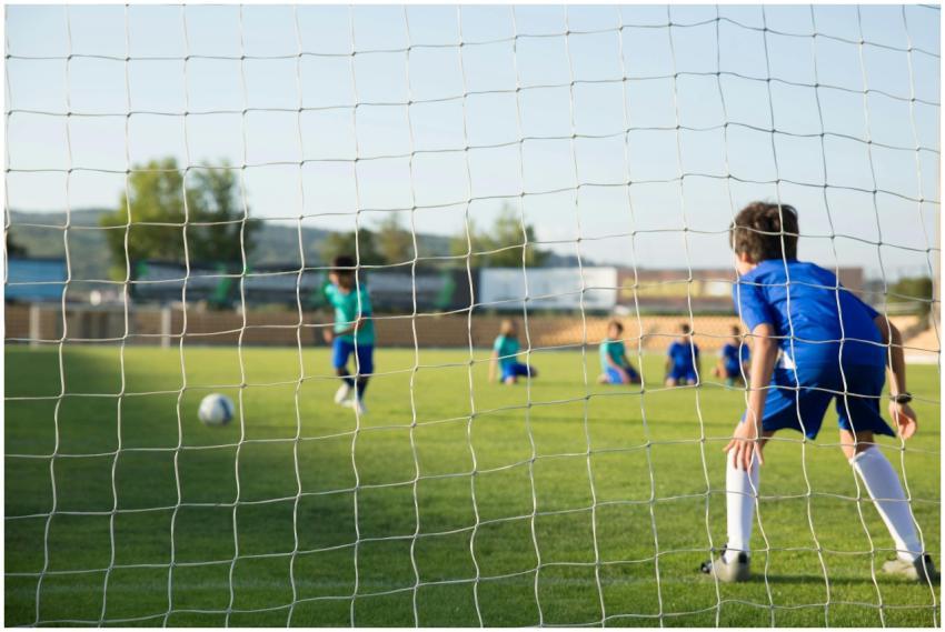Kids enjoying a soccer match on a sunny day in Por
