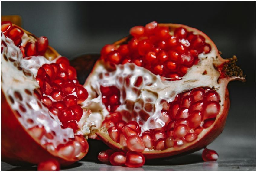 A close-up shot of a juicy pomegranate revealing v