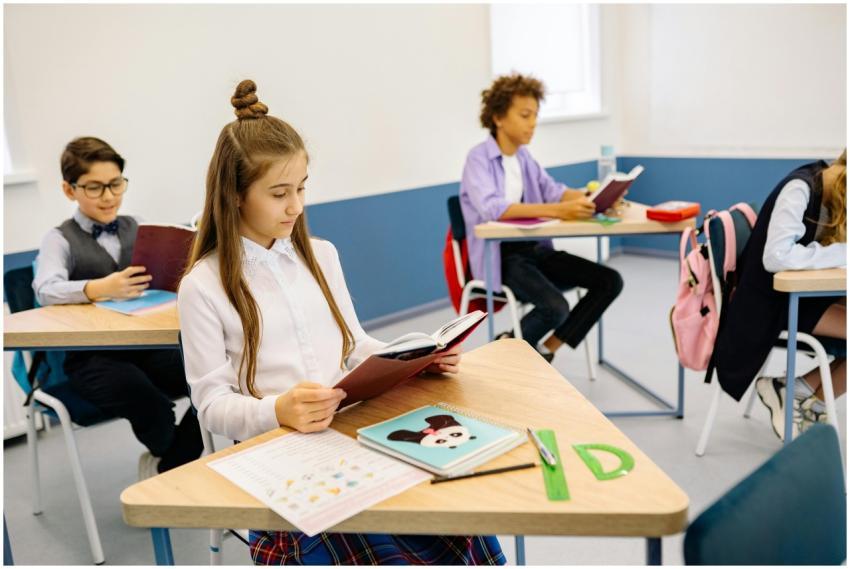 A diverse group of children attentively reading in
