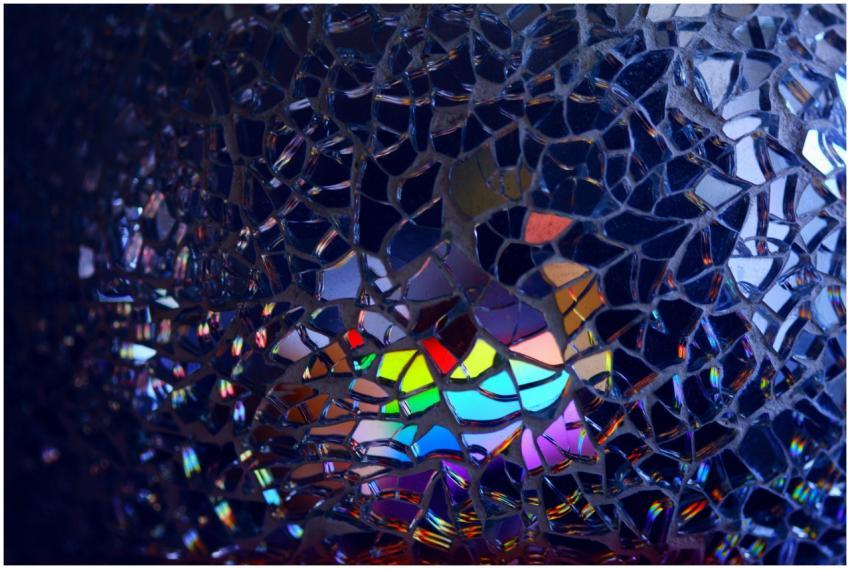 A colorful rainbow reflection through broken glass