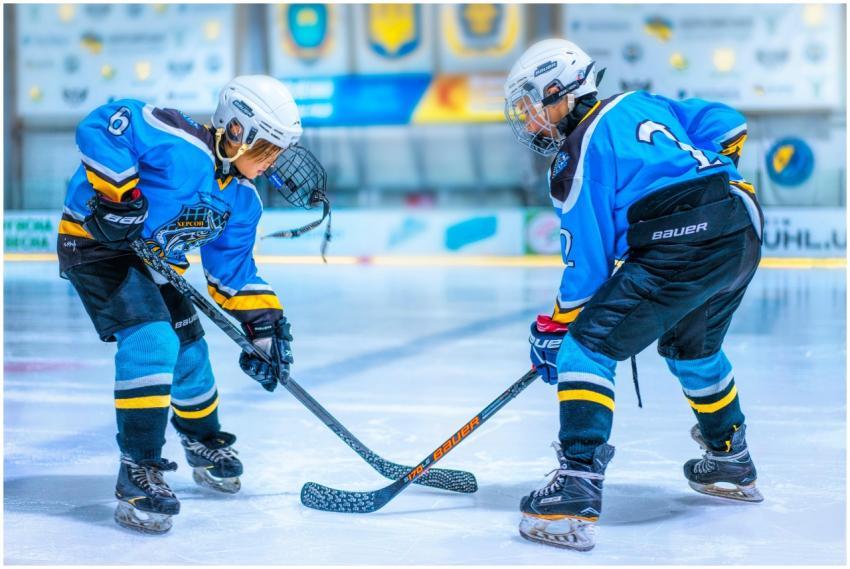 Two young athletes face-off during an ice hockey g