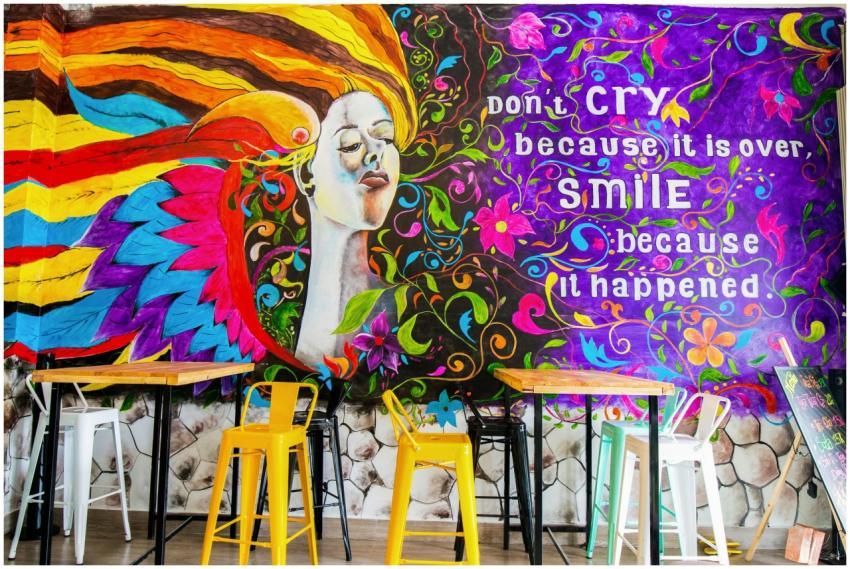 A vibrant mural with an inspirational quote and co