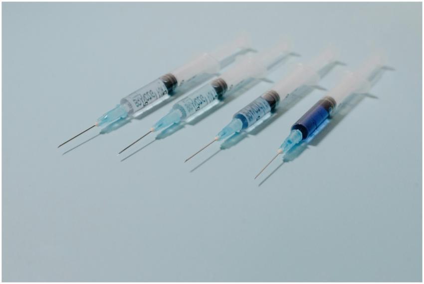 A collection of sterile syringes arranged on a blu