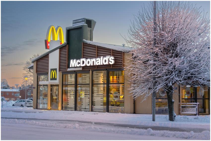 A snowy exterior of a McDonald's restaurant in Lud