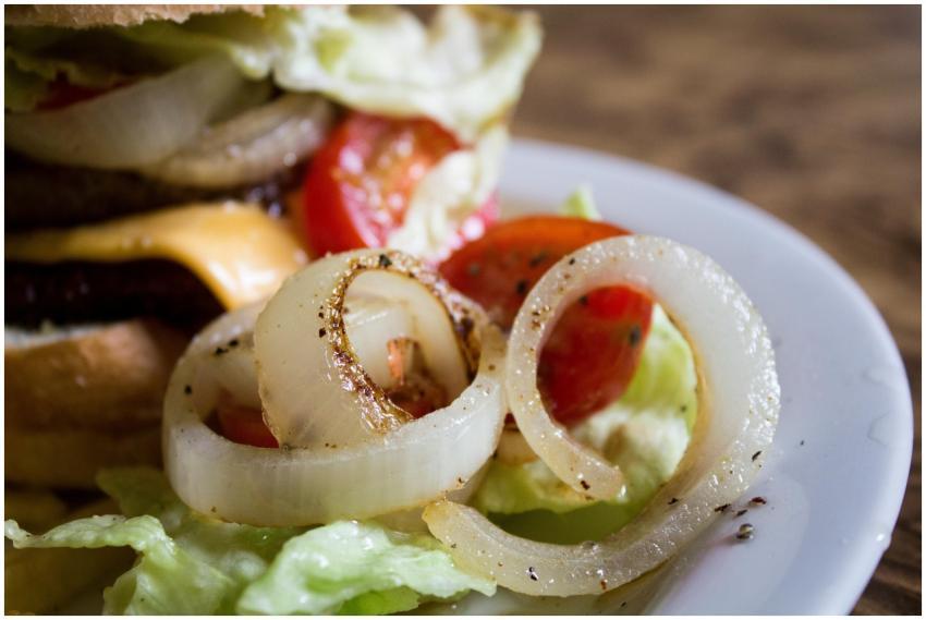 A mouthwatering close-up of a cheese burger with f