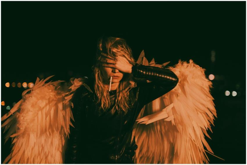 A person dressed as an angel with wings and blonde