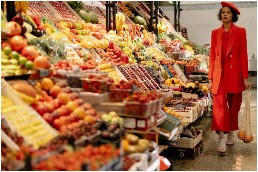 Stylish woman in red outfit shopping for fresh fru