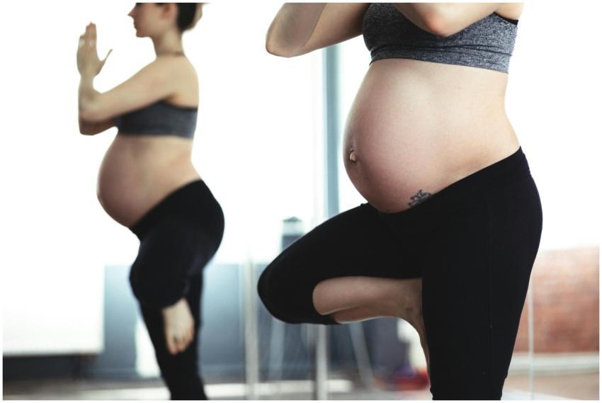 Pregnant woman doing yoga in front of mirror, prom