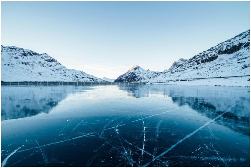 A serene winter landscape featuring a frozen lake