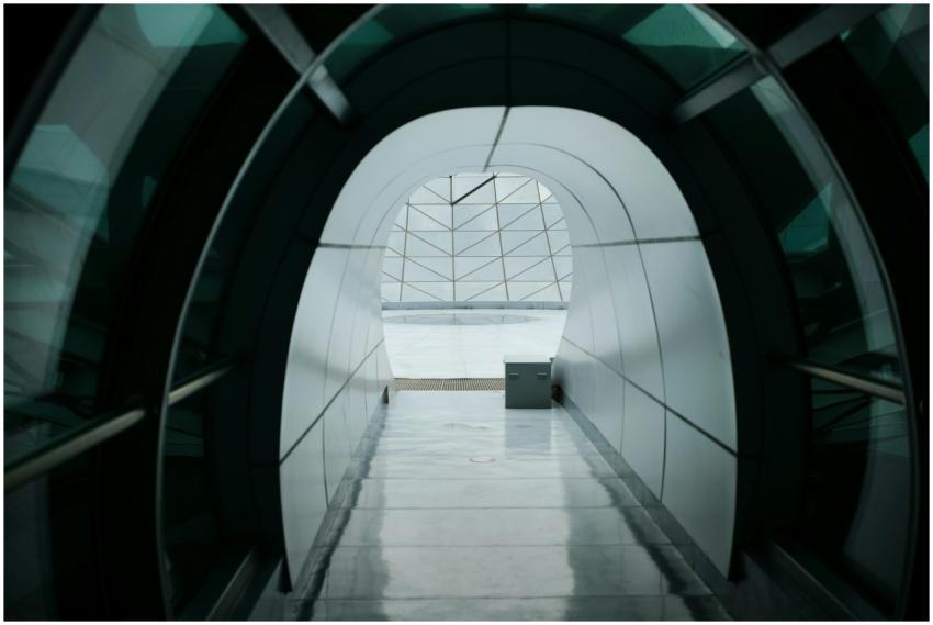 A modern, glass-arched corridor in Shanghai with a