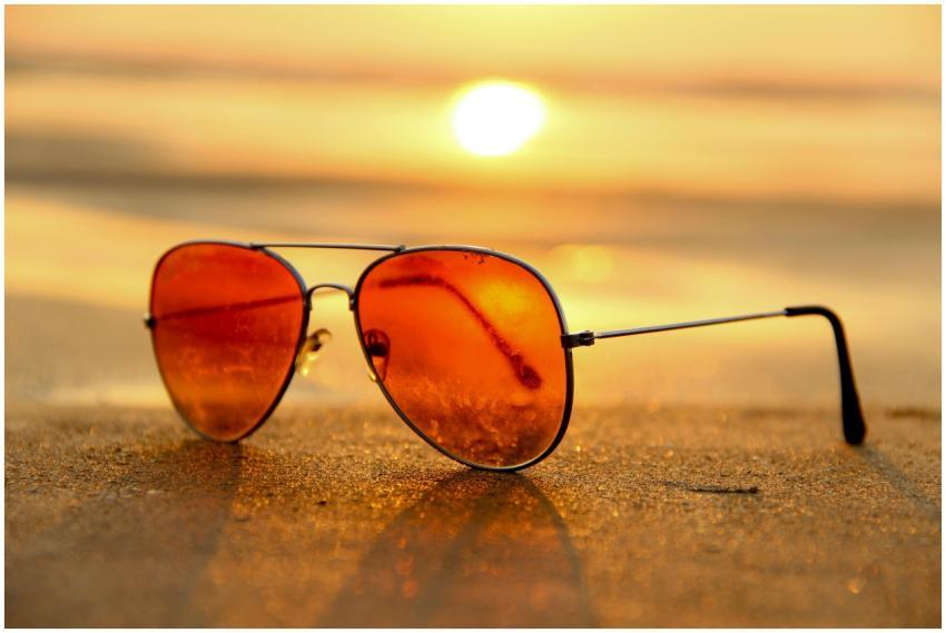 Close-up of sunglasses on a beach during a vibrant