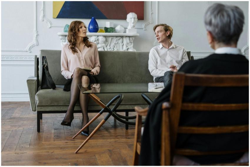 A couple having a discussion with a counselor in a