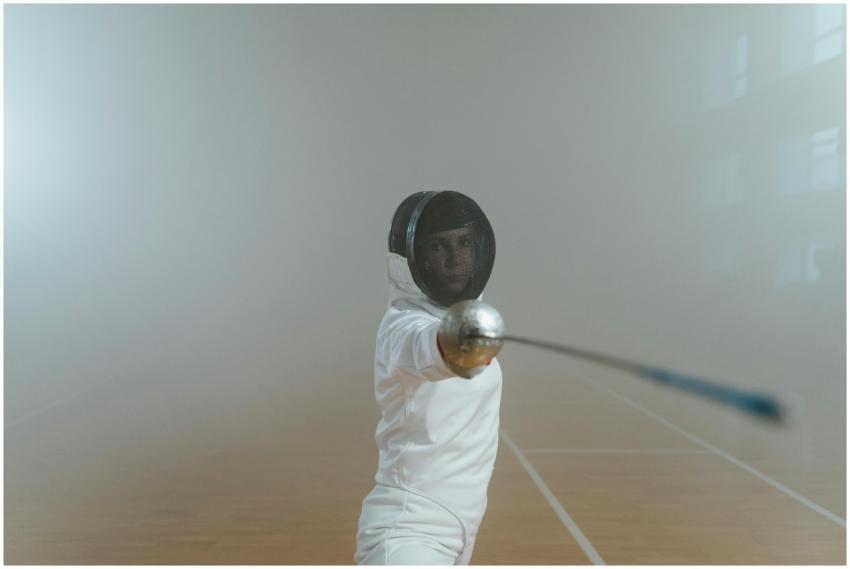 A female fencer in full gear executing a lunge in