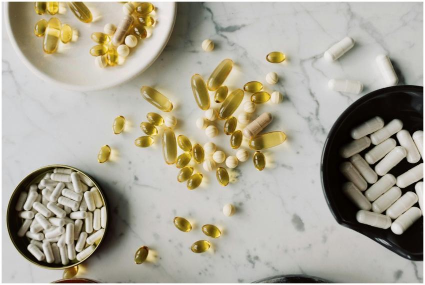 A flat lay of various capsules and tablets on a ma