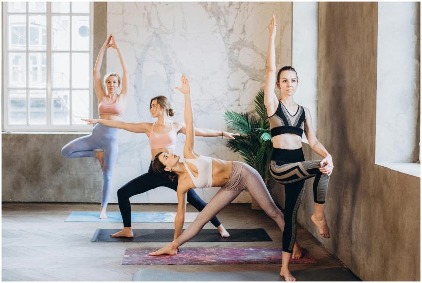 Group of women practicing yoga poses indoors in a