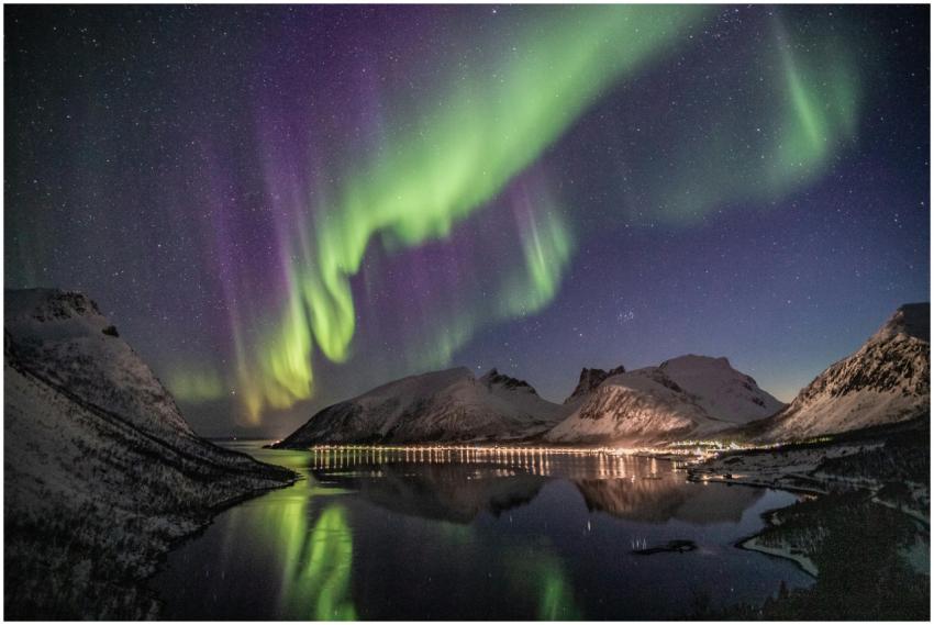 Beautiful aurora borealis over a snow-capped mount