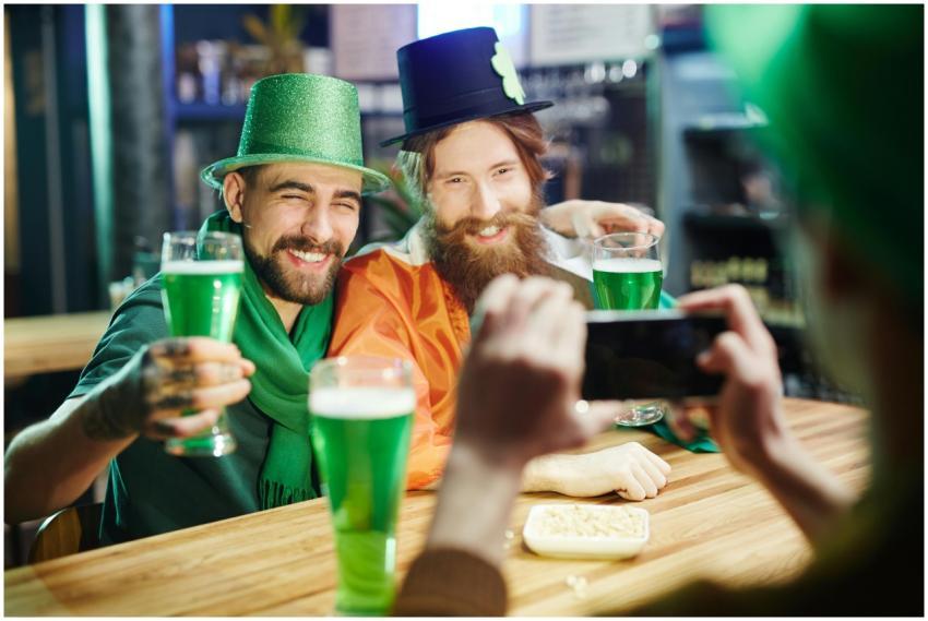 Two men in festive hats enjoying St. Patrick's Day