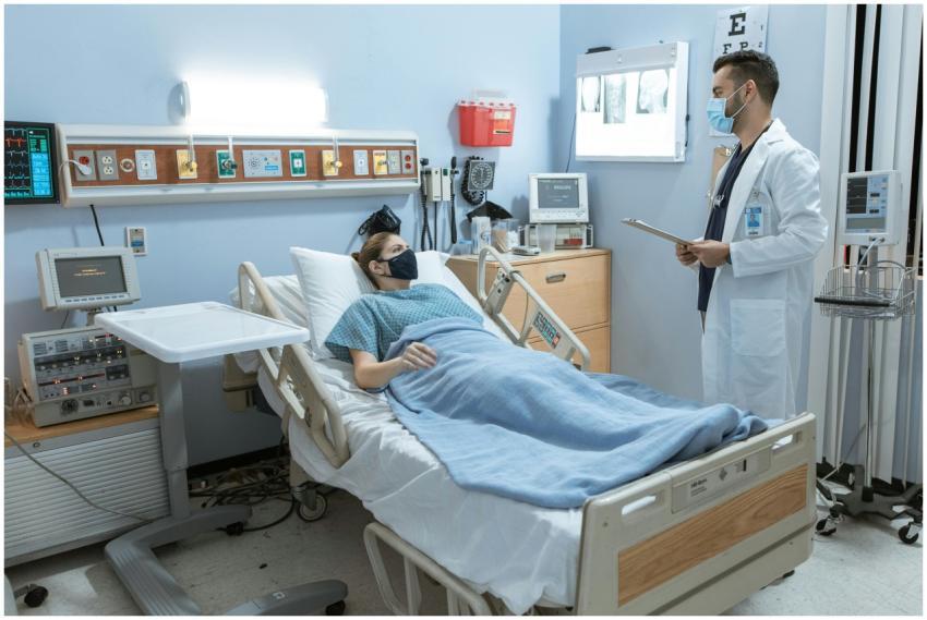 A doctor checking on a patient in a hospital room,