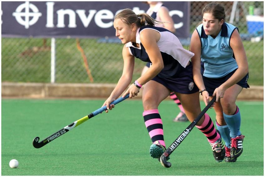 Dynamic action shot of women playing field hockey