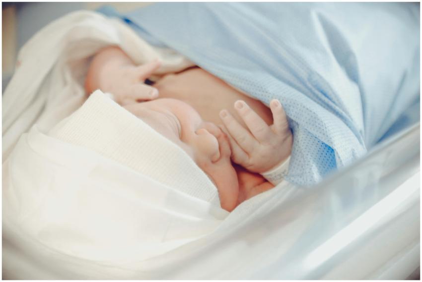 A serene newborn baby sleeping in a hospital, wrap