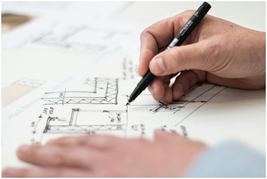 Close-up of hand drawing intricate technical desig