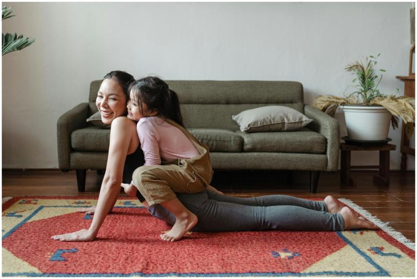 A joyful mother practicing yoga with her daughter