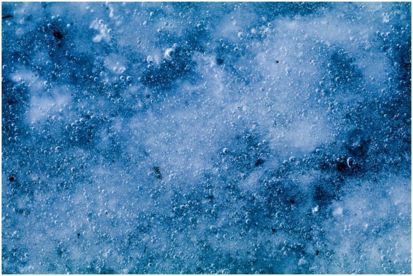 A close-up view of icy texture with bubbles, captu
