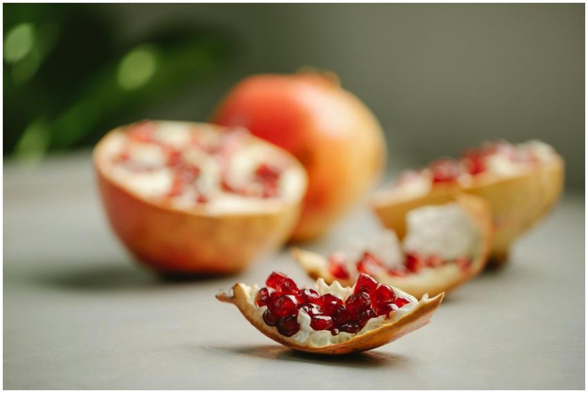 Chunk of ripe pomegranate with red seeds placed on
