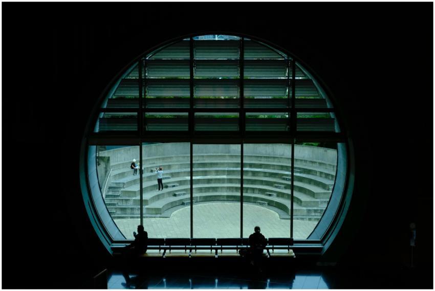 Silhouette of people through a circular window ove