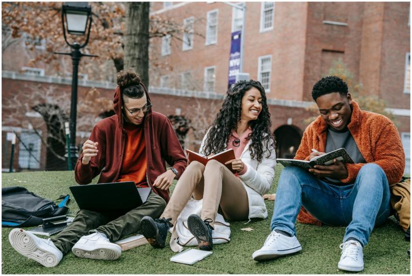 Full body of happy diverse students with notebooks
