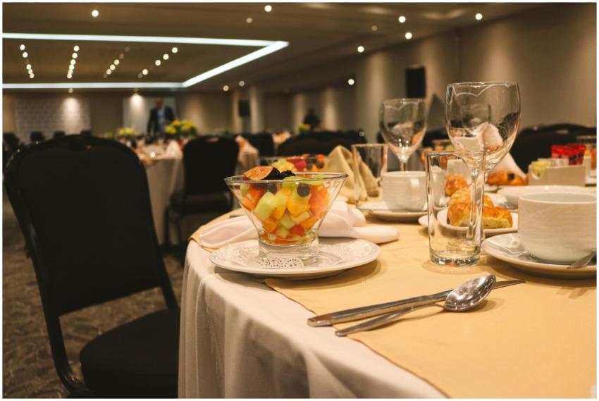 Elegant banquet table setting with fruit salad and