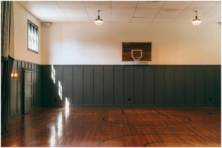 Empty indoor basketball court with wooden floor an