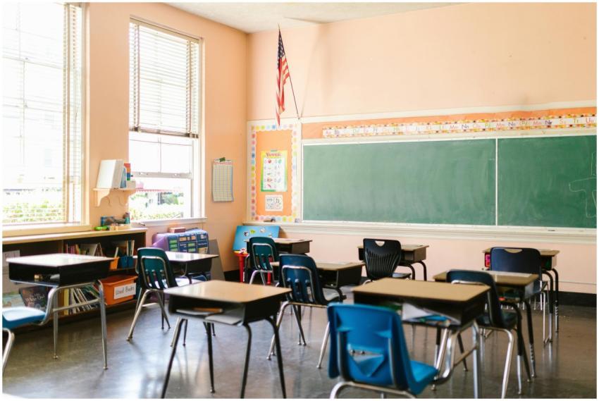 An inviting, sunlit classroom with empty desks and