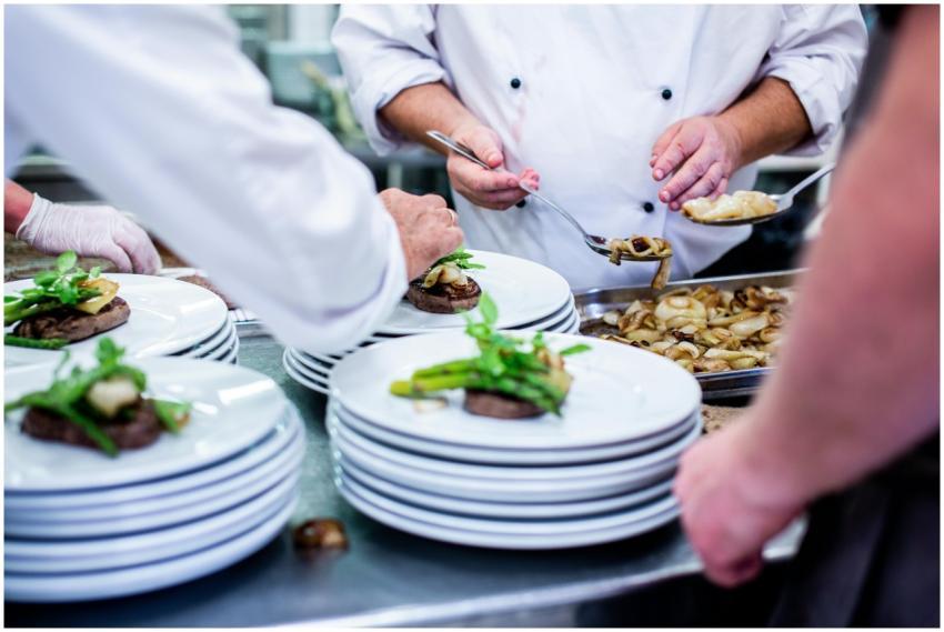 Chefs prepare and plate gourmet dishes in a profes