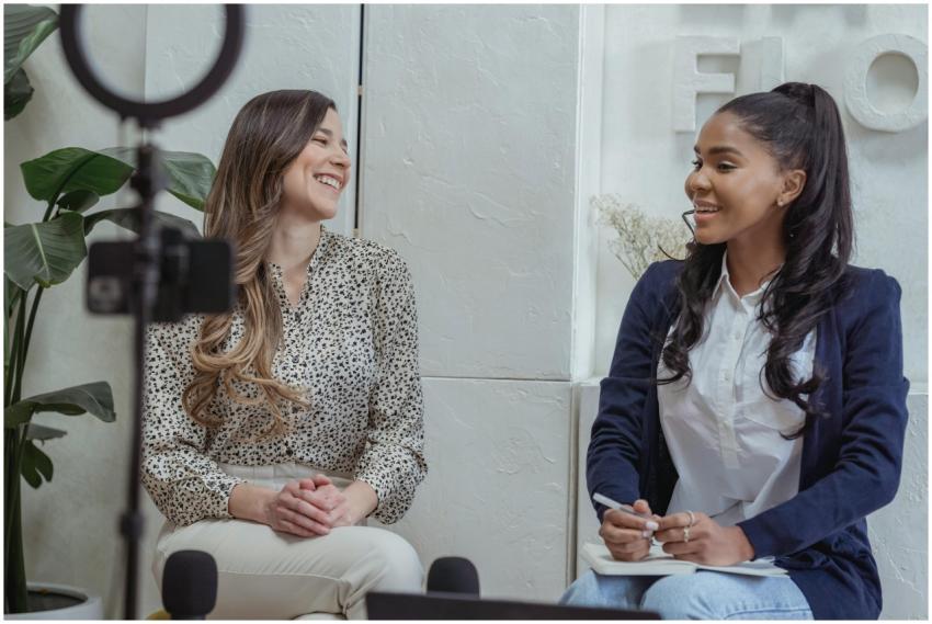 Two women engaged in a lively conversation in a pr
