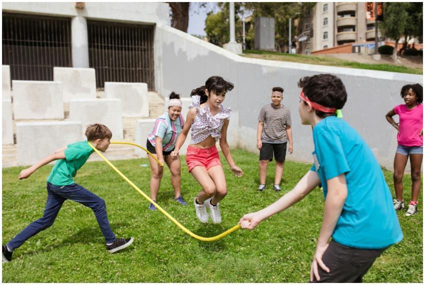 Group of kids enjoying a jump rope game outdoors o