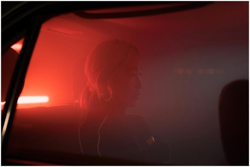 Silhouette of a woman sitting in a smokey car with