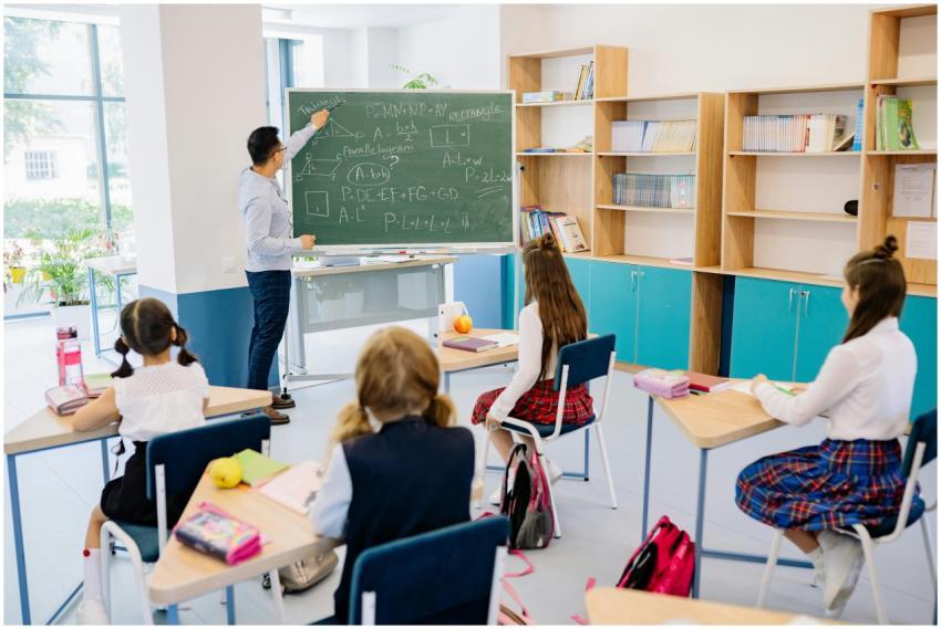 Children in a classroom focused on a math lesson w