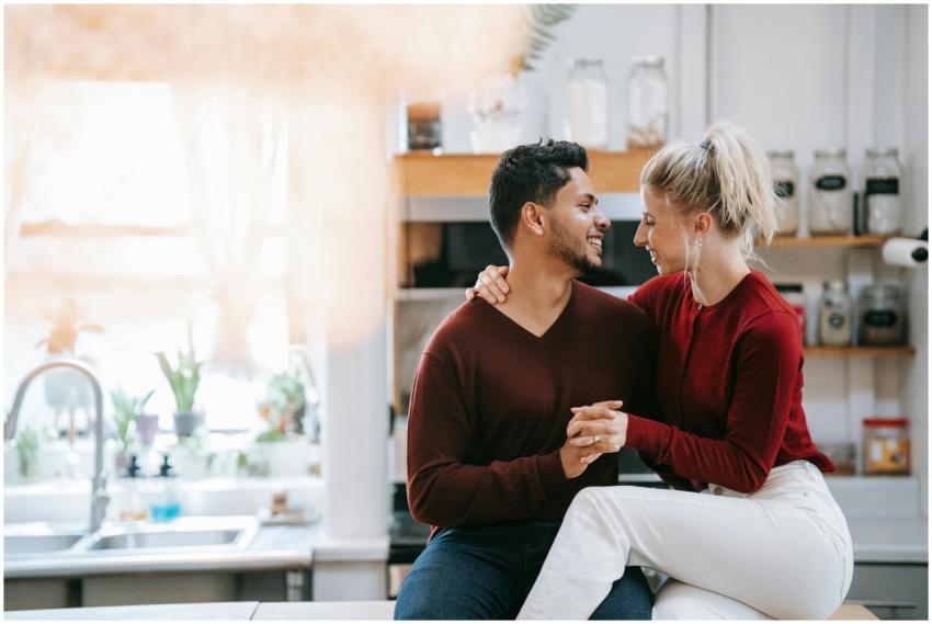 A joyful couple in a cozy kitchen, sharing a tende
