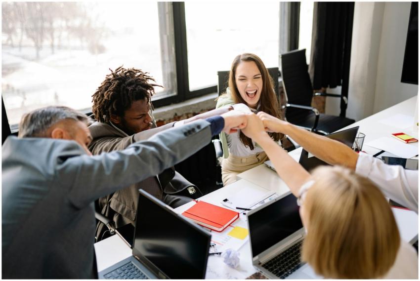 A diverse group of professionals celebrate a succe