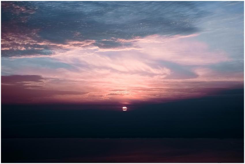 Beautiful sunset scene with clouds and calm ocean