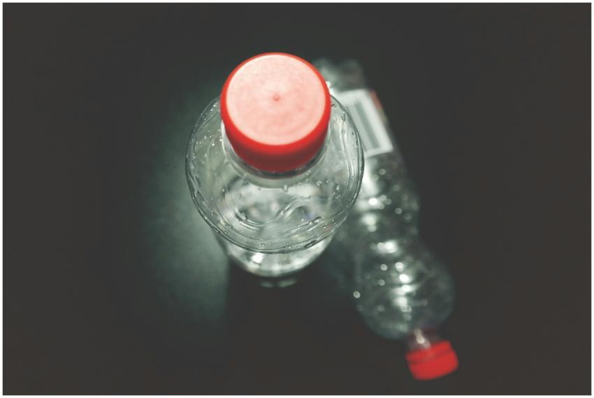 Top view of two clear plastic bottles with red cap