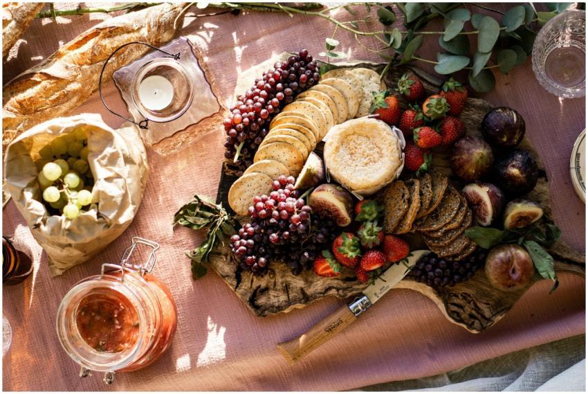 Elegant cheese platter with grapes, figs, and stra