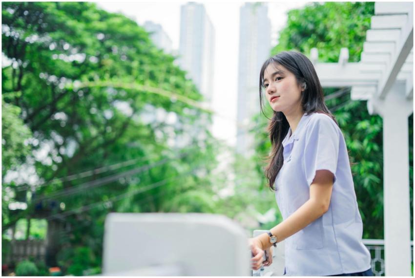 Portrait of a young woman outdoors, surrounded by