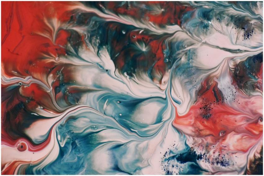Dynamic fluid painting with vibrant swirls of red,