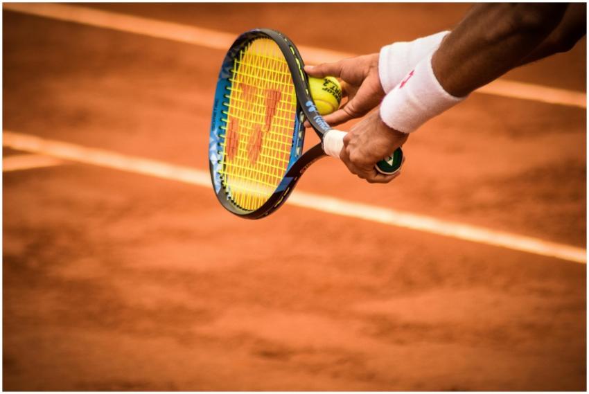 Close-up of a tennis player preparing to serve on