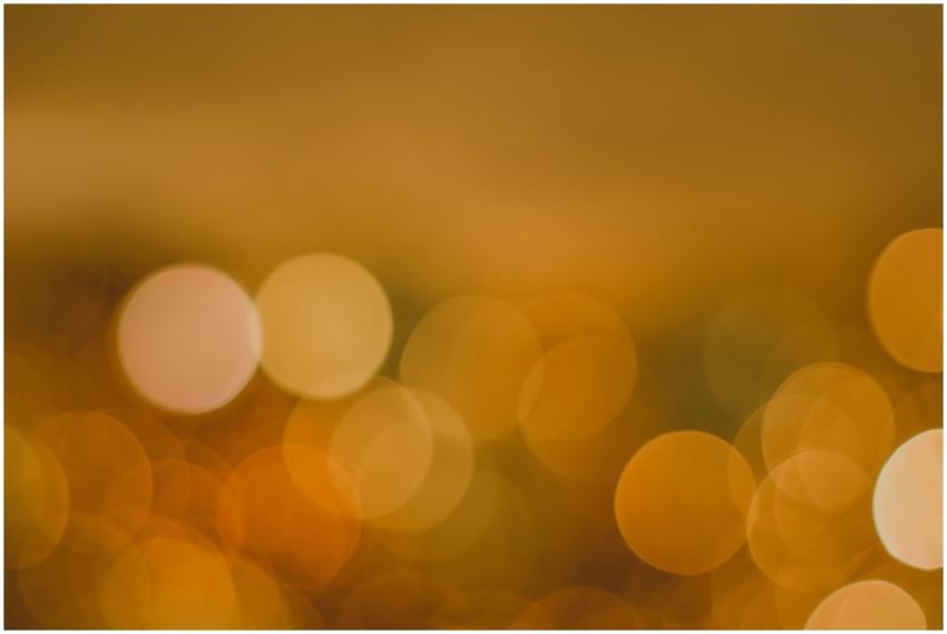 Abstract golden bokeh background with glowing circ