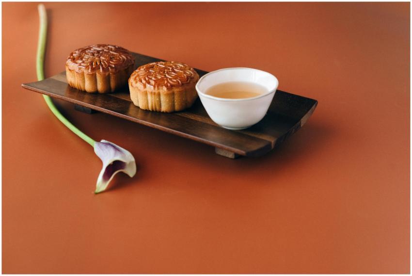 Traditional mooncakes and tea on a wooden tray, pe