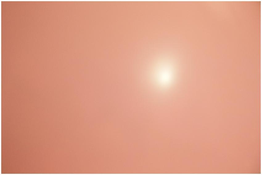 Dreamy soft peach pink background with bright sun,