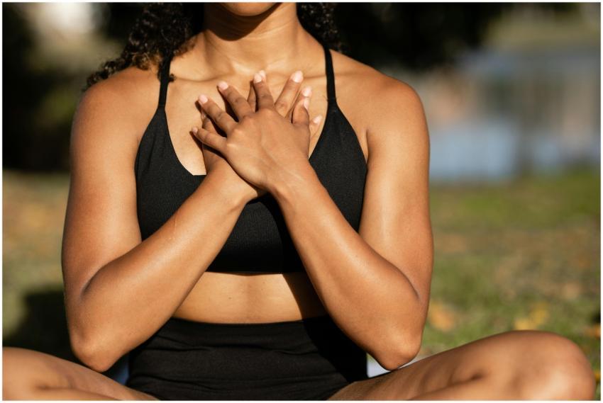 A woman in activewear practices mindfulness medita